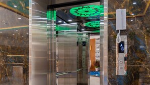 An elevator with a digital display, marble walls, and a modern interior design. - 126 Vung Tau Pool Villa Back Beach (Ho Chi Minh City)