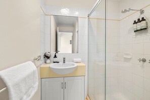 Shower, hair dryer, towels, shampoo