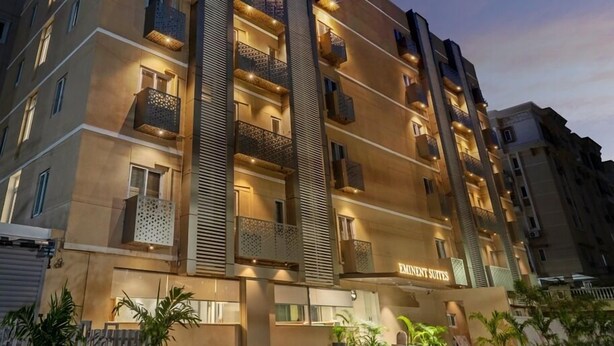 A multi-story hotel with balconies, a reception area, and a sign reading "Eminent Suites". - Eminent Suites & Apartments (Hyderabad)