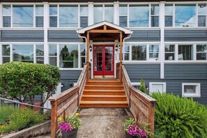 A building with a red door, wooden stairs, and a small porch. - #StayinMyDistrict Historic Heritage in Coos Bay (Coos Bay)