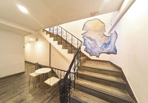 A staircase with a wooden finish and metal railings, leading to an upper floor. - comfy crib hostel  (Bangkok)