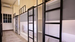 A corridor with bunk beds, a window, and an air conditioning unit. - comfy crib hostel  (Bangkok)