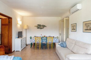Family Apartment, 2 Bedrooms, Sea Facing (La Casina Del Pescatore On the Beach) | Living area | 21-inch flat-screen TV with cable channels, TV