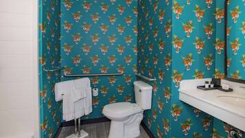 A bathroom with a toilet, sink, and towel rack.
