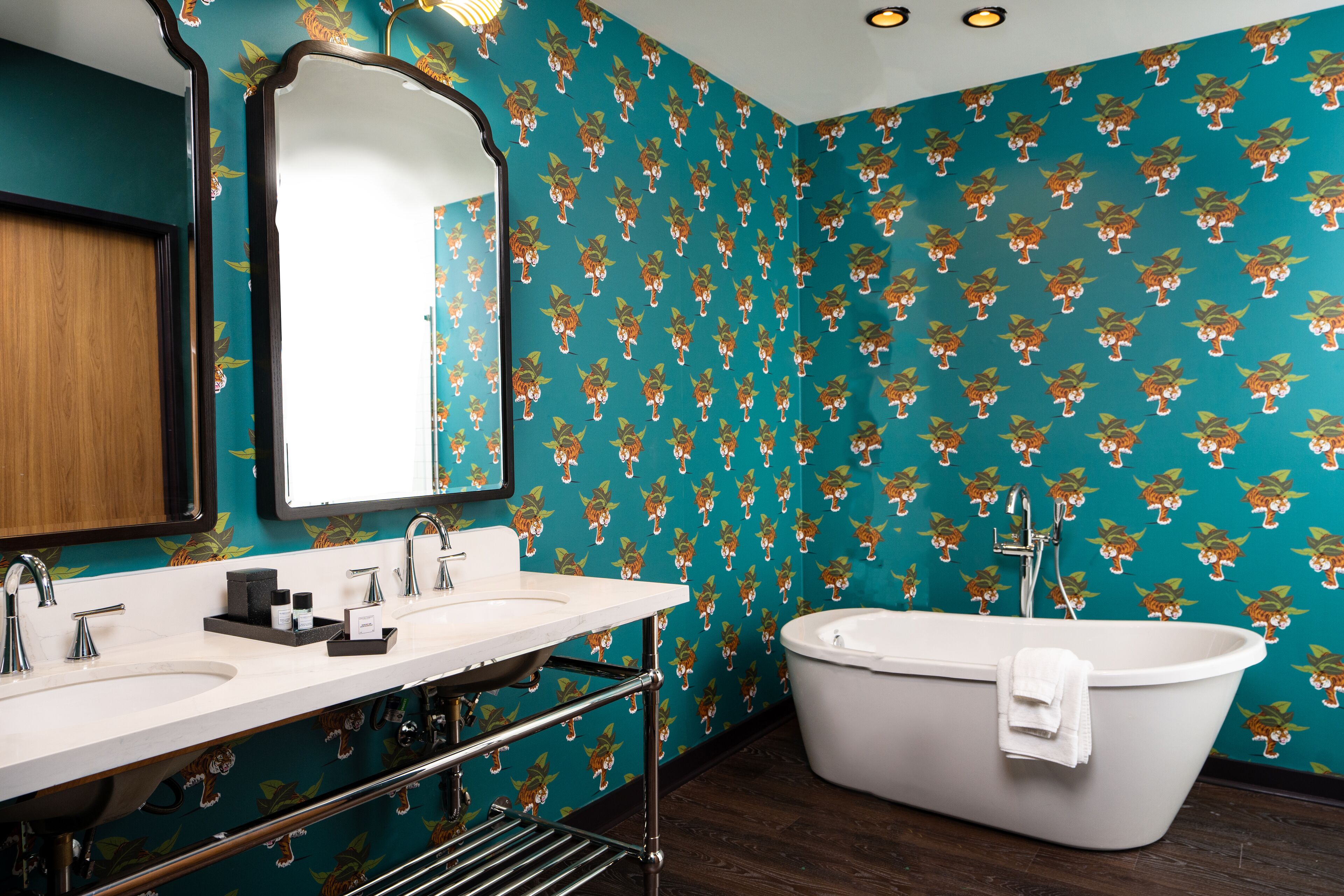 A bathroom with a large bathtub, two sinks, and a mirror.