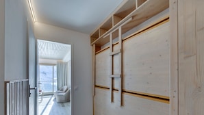 A modern interior with a wooden wall unit, a ladder, and a view to a balcony. - Charming renovated apartment for 4 in Tignes with lake view (Tignes)