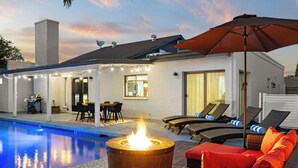 A poolside area with a fire pit, outdoor seating, and a covered patio. - Dobson Ranch, Farmhouse Casual, Pool & Games! (Mesa)