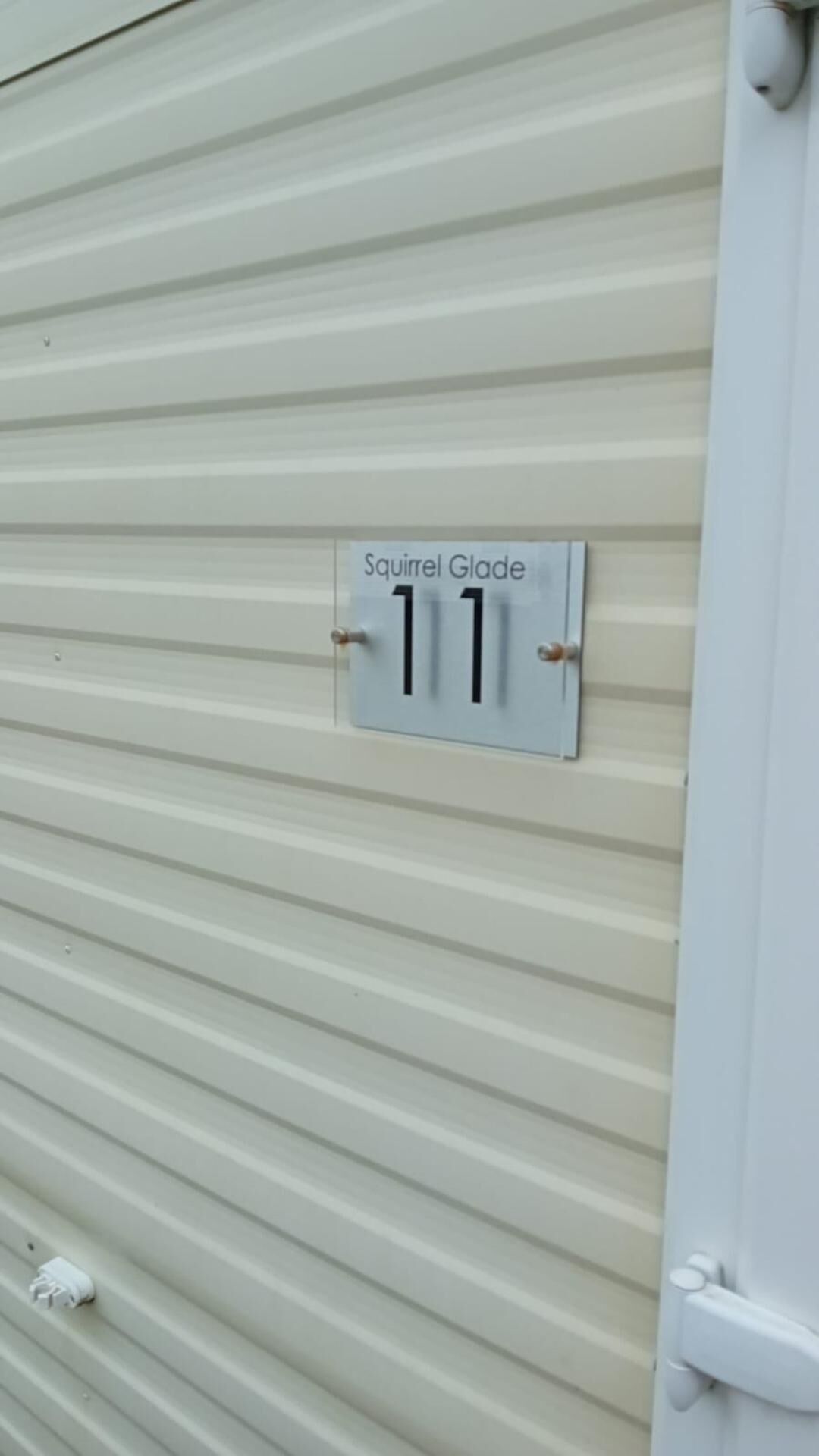 A metal shutter door with a label reading "Squirrel Glade 11".