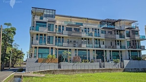 A multi-story modern building with large windows and balconies. - Miguo Homestay (Wujie)