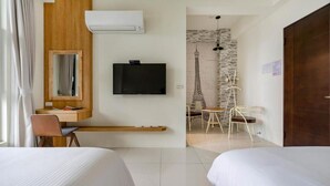 A hotel room with two beds, a desk with a chair, a television, an air conditioning unit, and a view of the Eiffel Tower through a glass door. - Miguo Homestay (Wujie)