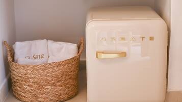 A woven basket with a white cloth labeled "na Sona" and a cream-colored appliance with the word "CREATE" on it.