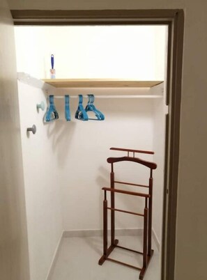 Simple, functional space with a drying rack and shelf.