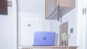 A hotel reception desk with a laptop, a door labeled "TOILET," and a sign with the hotel's name. - A Heritage Hotel Split (Split)
