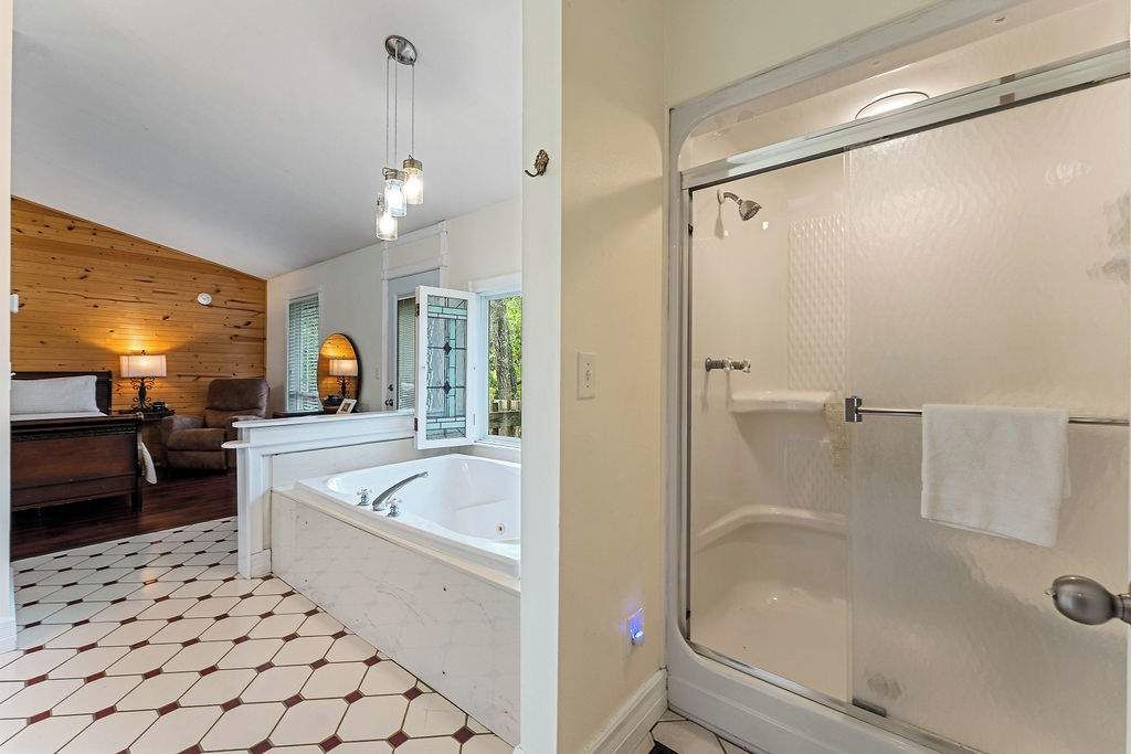 A bathroom with a bathtub, a shower, and a toilet.