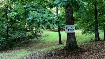 A sign indicating a nature trail in a wooded area.