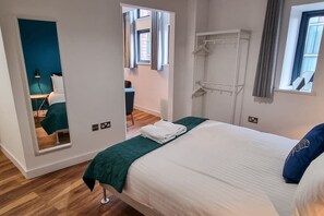 Relax in this stylish room with a large bed, window with city views, and a convenient wardrobe.