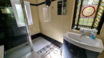 Shower, hair dryer, towels, shampoo