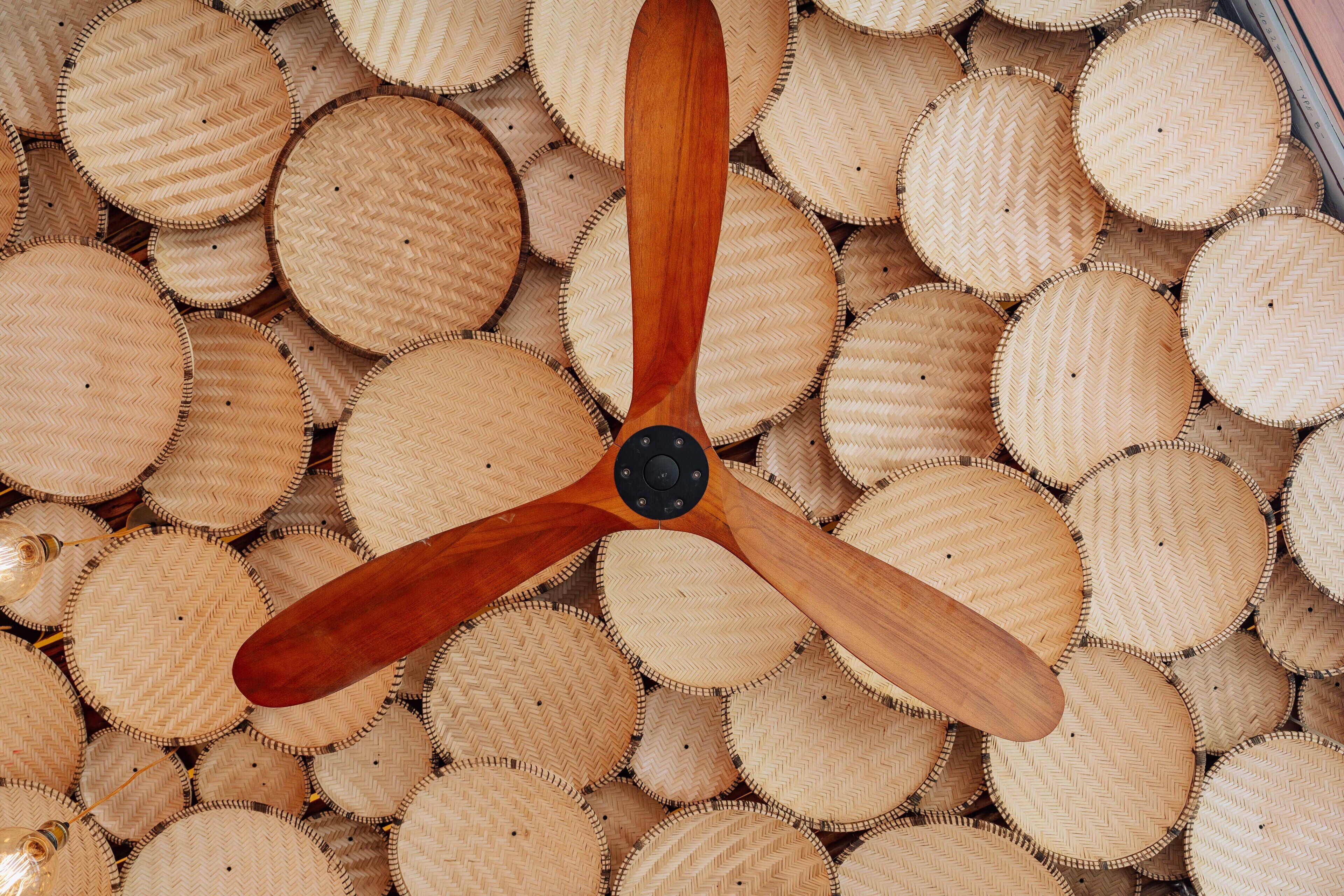 A wooden propeller with a central hub, surrounded by circular woven mats.