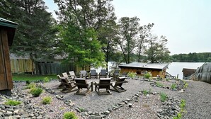 A patio area with outdoor seating and a view of a lake. - Moose Ridge at The Spot on Buskey Bay of the Pike Chain of Lakes in Iron River, WI (Iron River)