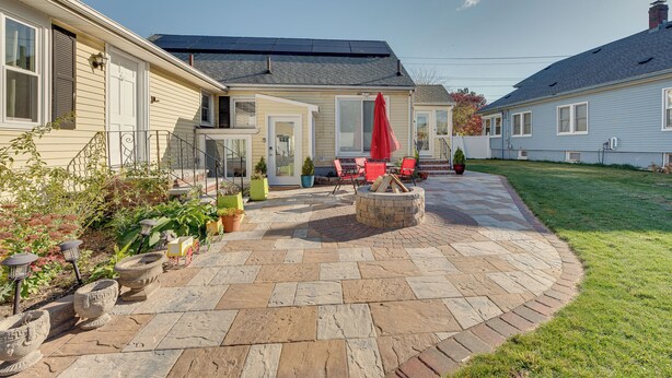 A patio with stone tiles, a fire pit, and outdoor furniture. - 1 Mi to Downtown: Salem Vacation Rental! (Salem)