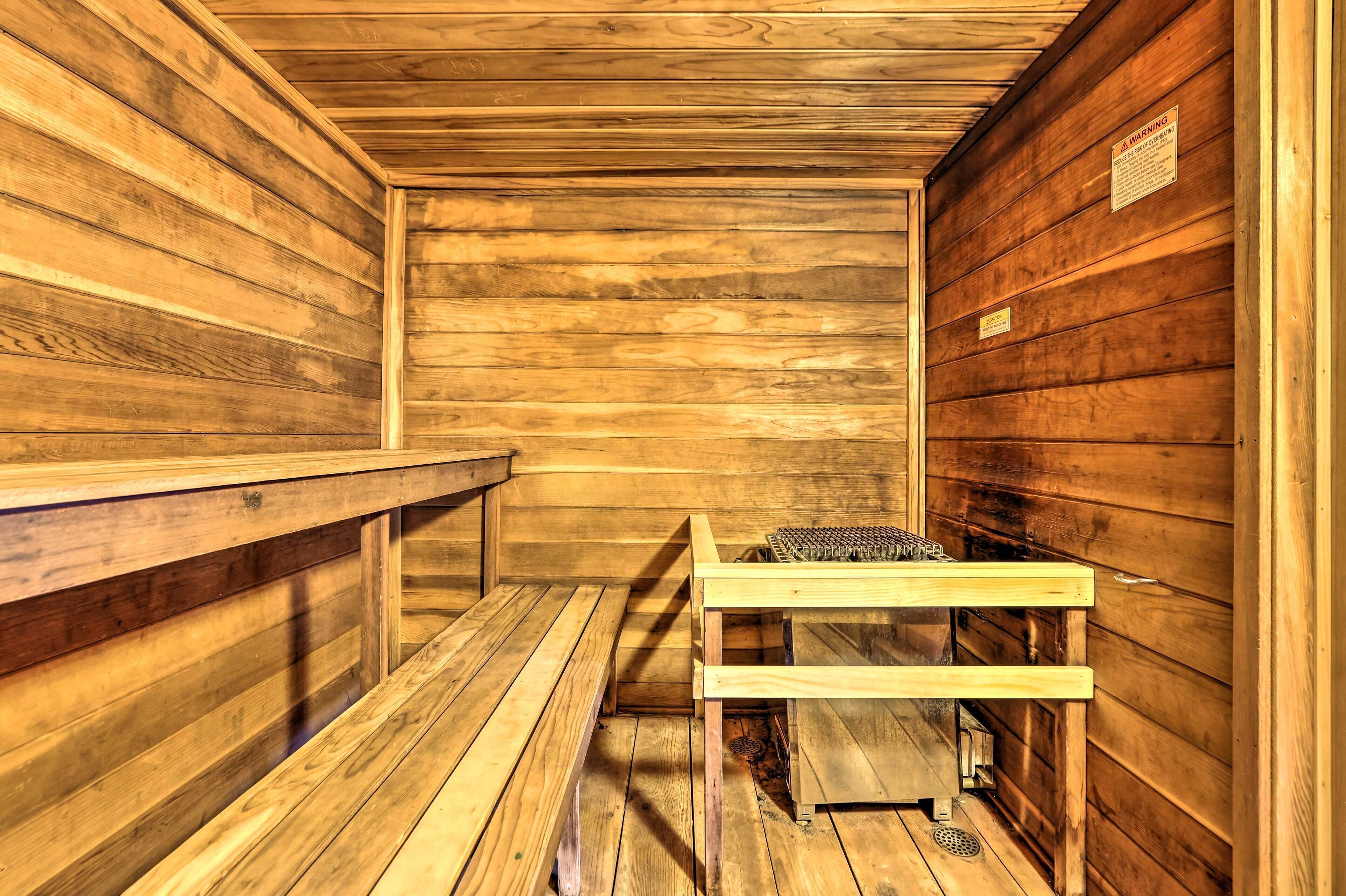 A sauna with wooden benches and a bench with a towel rack.