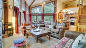 A spacious living room with a high ceiling, large windows, and a kitchen area. - Ski & Golf: Cozy North Conway Mountain Cabin! (North Conway)