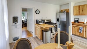 Une cuisine avec des meubles en bois, un réfrigérateur en acier inoxydable, un four à micro-ondes et une cuisinière.