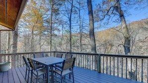 A wooden deck with a table and chairs, overlooking a forested area. - Mtn-view Waynesville Home Near Trout Stocked Creek (Waynesville)