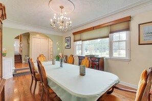 Enjoy meals with family and friends at the dining table for four, set with a crisp white tablecloth.