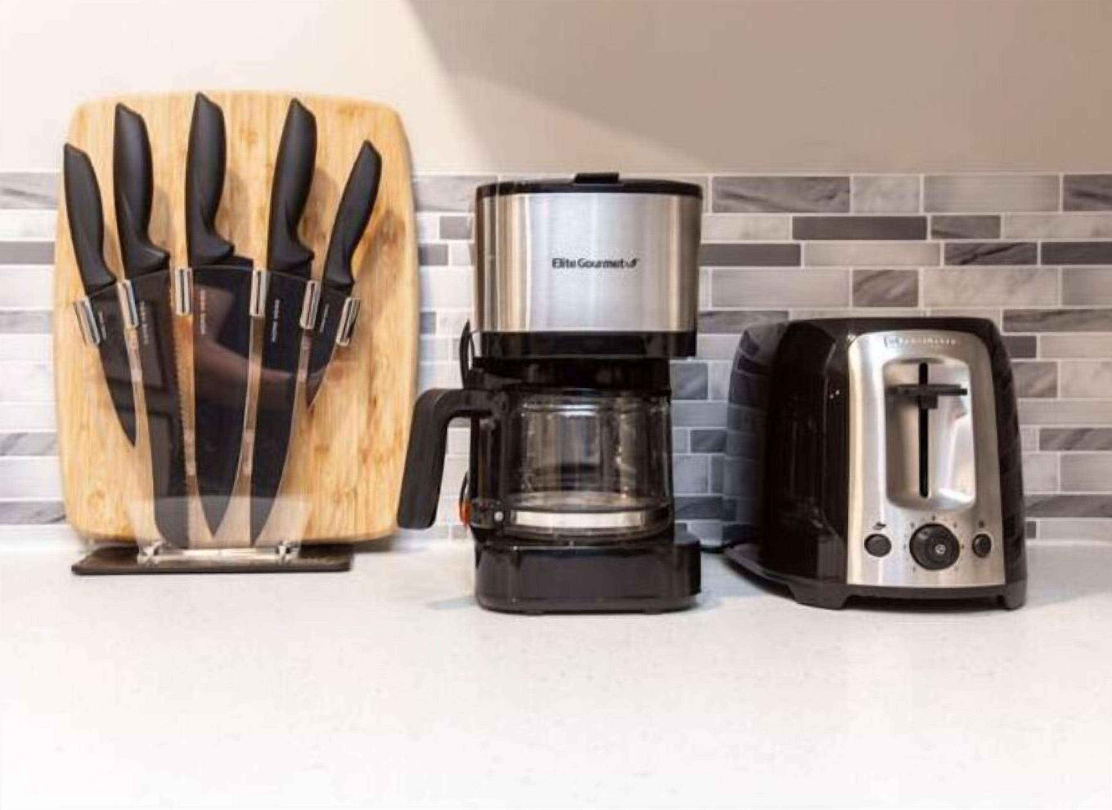 A kitchen counter with a knife block, a coffee maker, and a toaster.