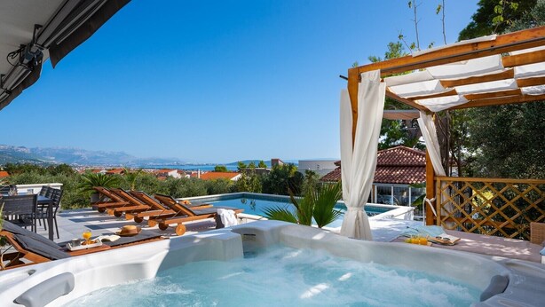 A hot tub with lounge chairs and a pool, overlooking a scenic view. - Villa Lea with 4 bedrooms, 40sqm pool, Hot-Tub, 2km from the beach (Kastel Novi)