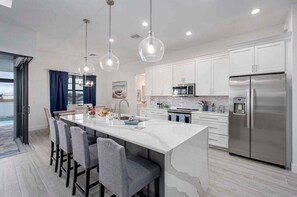 Fridge, microwave, oven, stovetop - Castaway Cape - Luxury Rental with Outdoor Kitchen (Cape Coral)