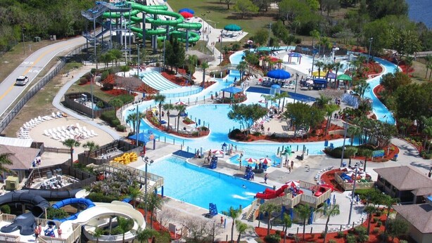 A water park with a large pool, multiple slides, and a wave pool.