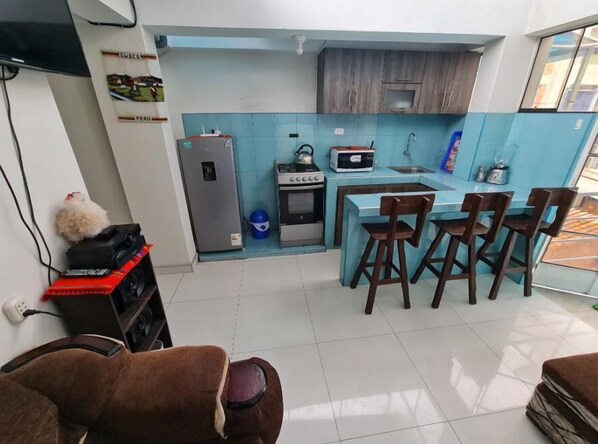 Fridge, microwave, cookware/dishes/utensils, dining tables