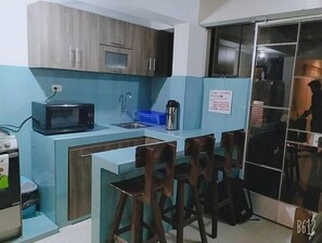 Fridge, microwave, cookware/dishes/utensils, dining tables