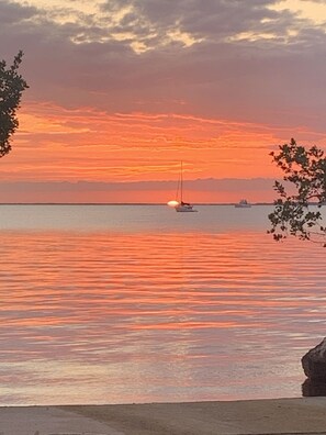 A sunset over a calm sea with boats. - Beautiful Key Largo Bayside Condo! (Key Largo)