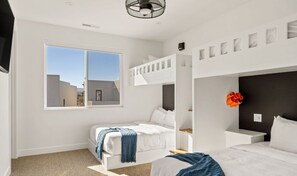 Cozy urban retreat with a bunk bed arrangement and a large window offering a view of the surrounding buildings.