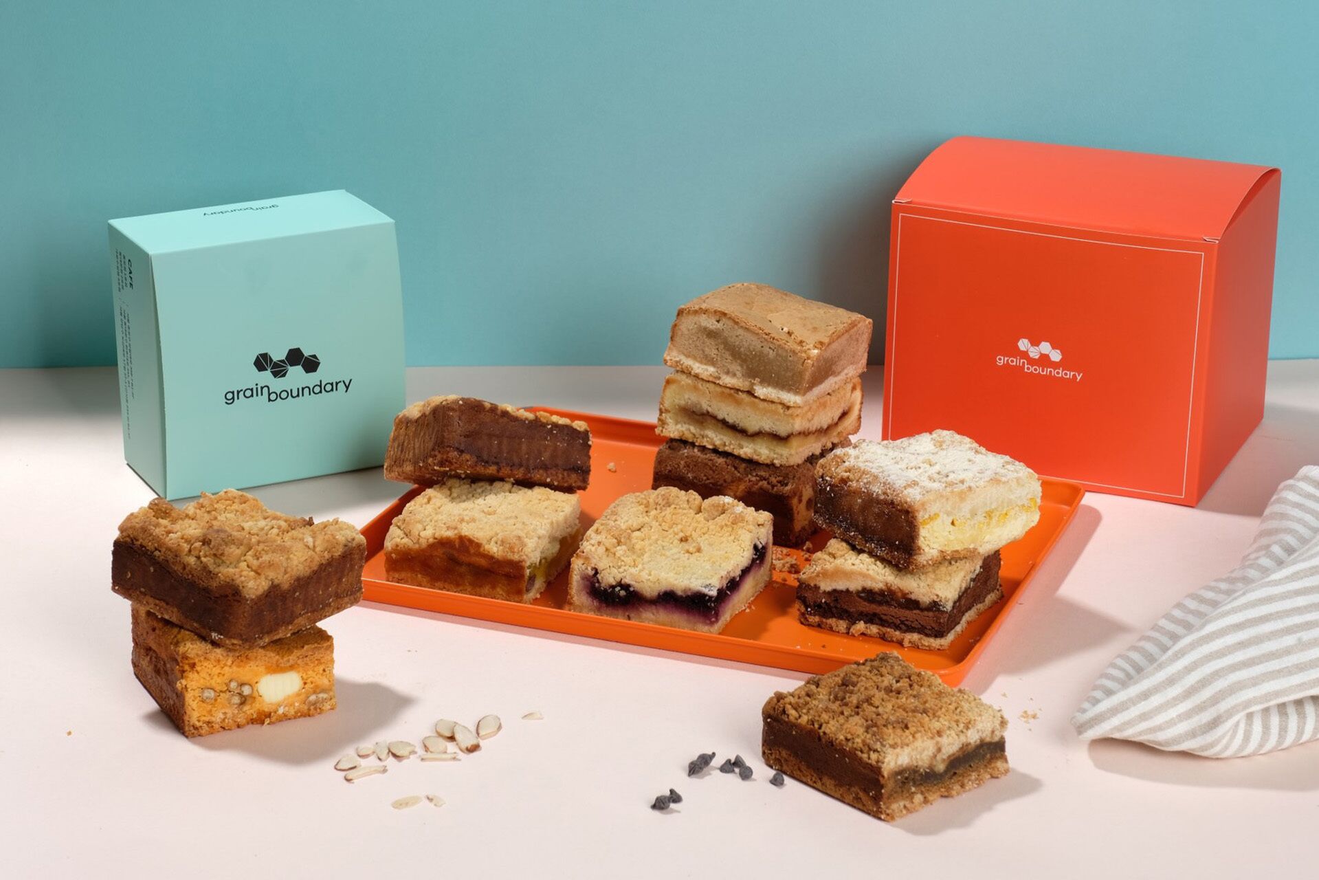 A variety of desserts on a tray, with two boxes labeled 'grain boundary' in the background.