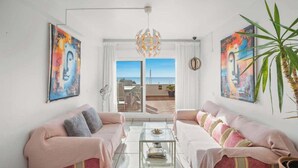 A living room with two sofas, a coffee table, and a view of the sea. - Benalmadena over the sea by Costarentals - Ref 17 (Benalmádena)