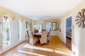 Enjoy a spacious room with a dining area, large windows, and a comfortable bed.