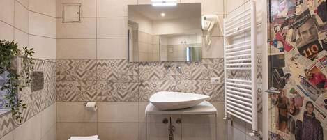 A bathroom with a white sink, toilet, and mirror.