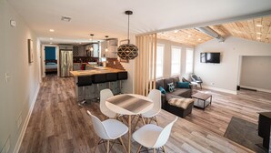 A modern living space with a kitchen, dining area, and seating area. - Fully remodeled house in perfect location (Irons)