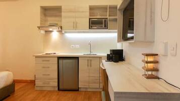 Fridge, microwave, coffee/tea maker, cookware/dishes/utensils