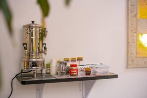 Enjoy a selection of coffee and drinks in this cozy bar area, featuring an espresso machine and a variety of cups.