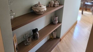 A kitchen shelf with various kitchenware items. - Home-spirit apartment with a panoramic window in the heart of Klaipėda! (Klaipeda)