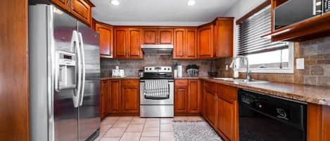Enjoy cooking in this well-equipped kitchen with an oven, dishwasher, and refrigerator.