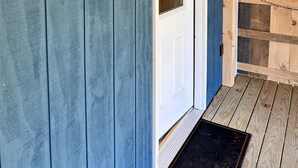 A wooden sign with the text "Le Chalet à Jay" and a door with a glass panel. - Brand New, Private Home w/ Nordic Hot Tub- Just 1/2 mile to Jay Peak Resort (Jay)