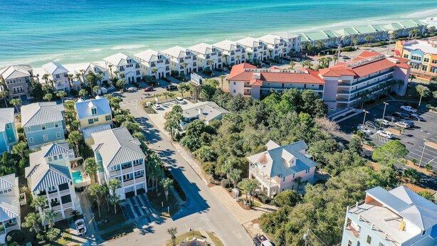 A coastal resort with beachfront villas, a central parking area, and a view of the ocean. - Destin Beach House - Flamingo Cove (Miramar Beach)
