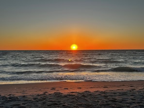 A sunset over the ocean with waves approaching the shore. - Come get lost in Southwest Florida's paradise! (Fort Myers)