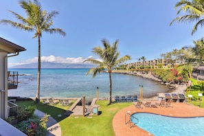 A pool area with lounge chairs, a small pool, and a view of the ocean. - Snorkel with sea turtles! Ocean Front & Pool! (Lahaina)